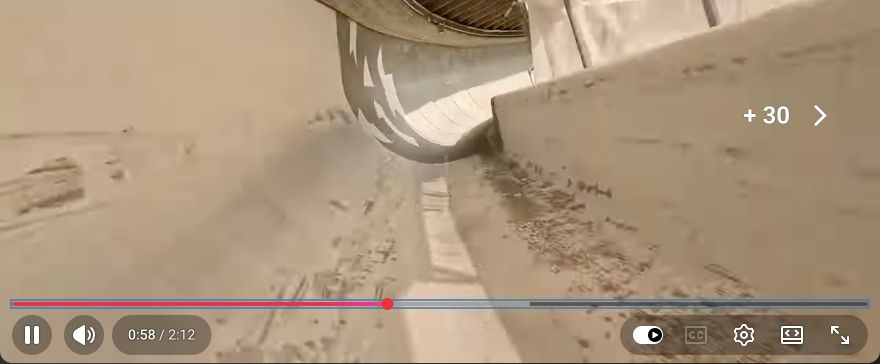 Recovered YouTube screenshot at 0:58 showing the high wall of a banked bobsled turn