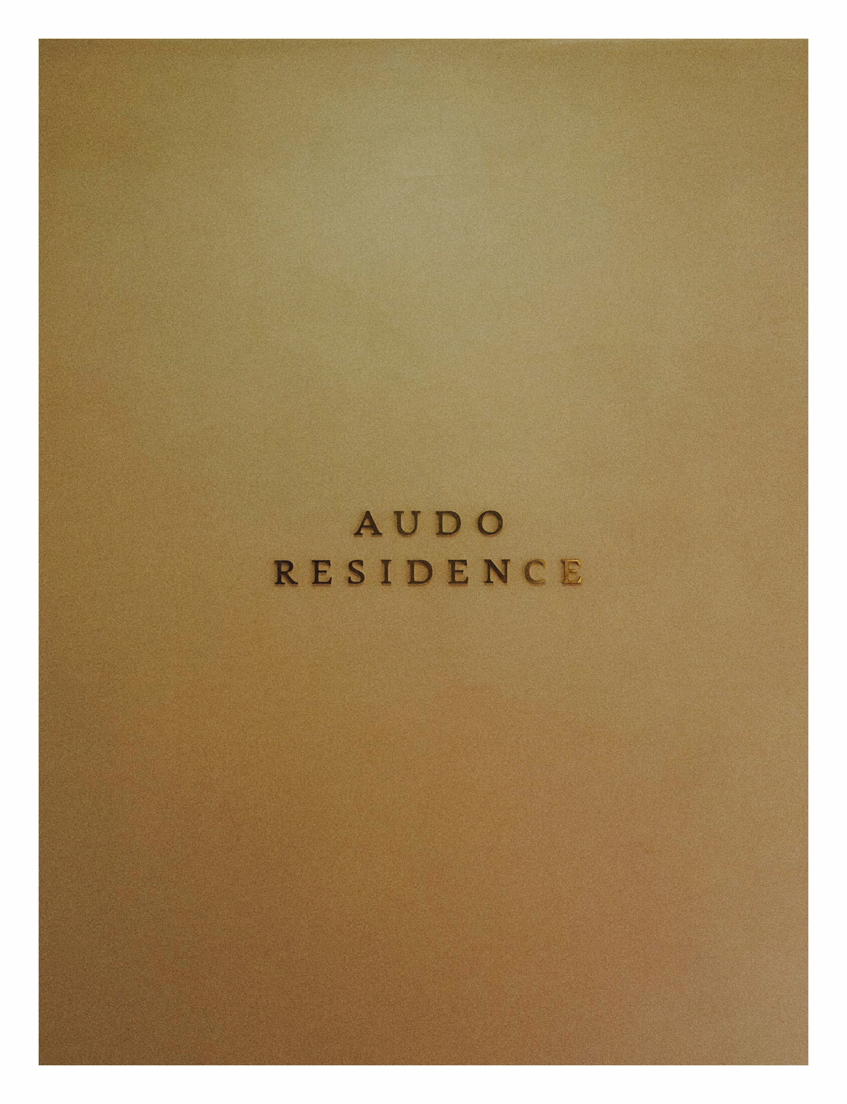 Tan cover embossed with the words Audo Residence