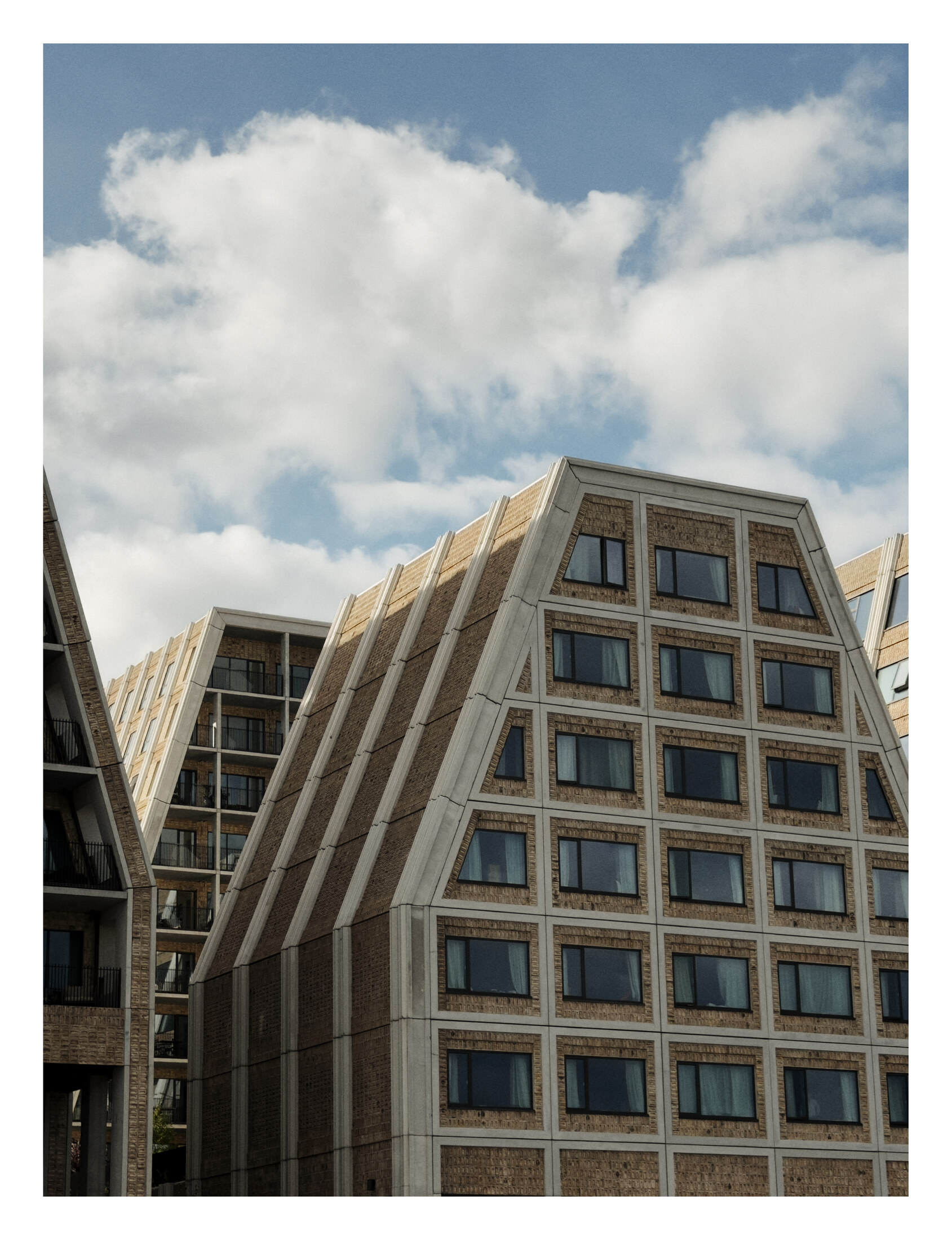 Angular brick and concrete buildings rising above the Copenhagen waterfront