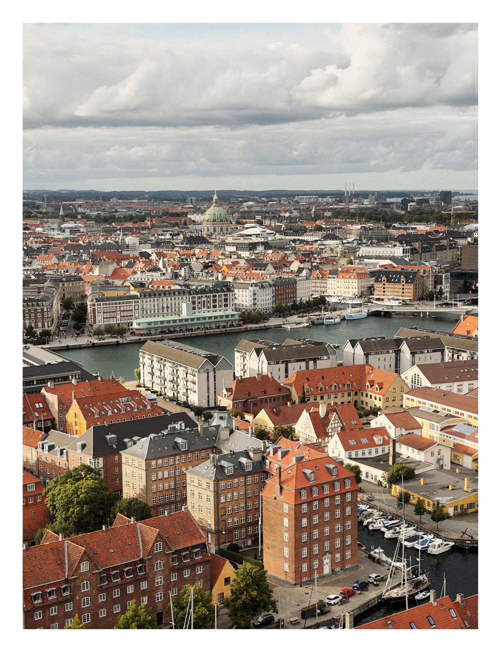Copenhagen rooftops, towers, and canals seen from the steeple of Vor Frelsers Kirke